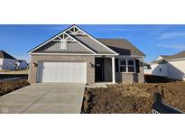 Charming single-story home with brick facade, a two-car garage and clean, modern architectural design at 6222 Granby Dr, Whitestown, IN 46075
