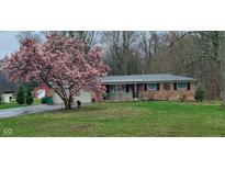 Charming brick home with a beautifully blooming magnolia tree in the front yard at 8190 Beech Grove Rd, Martinsville, IN 46151