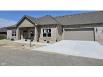 Charming single-story brick home with a two-car garage and concrete driveway at 2327 Saddle Dr, Shelbyville, IN 46176
