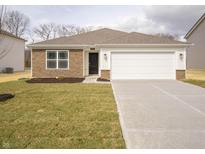 Charming one-story home with stone accents, attached garage, and a well-manicured lawn at 6112 Card Blvd, Indianapolis, IN 46221