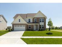 Charming two-story brick home with a well-manicured lawn and attached two-car garage at 1105 Gatewick Ct, Greenwood, IN 46143