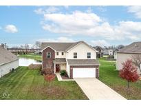 Two-story brick home with a large yard and pond view at 1215 Boulder Ln, Fortville, IN 46040