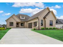 Stunning home with painted brick, black trim, and a spacious two-car garage at 5469 Harness Dr, Greenwood, IN 46143
