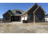 New construction, brick home featuring an attached two car garage and modern window designs at 5469 Harness Dr, Greenwood, IN 46143