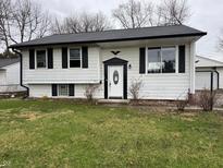 Charming home with black shutters, white siding, and a well-maintained lawn and front door at 5625 Gateway Dr, Indianapolis, IN 46254