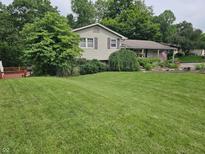 Charming home with a well-manicured lawn and mature trees, providing a serene and inviting atmosphere at 620 Valley Dr, Martinsville, IN 46151