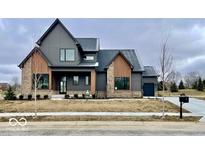 Two story home with gray siding, brick accents, and a landscaped lawn at 4325 Hamilton Run, Zionsville, IN 46077