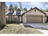 Charming home with a two-car garage, stone accents, and dormer windows at 8191 Frisco Way, Indianapolis, IN 46240