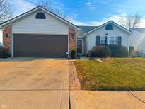 Charming home with a one-car garage, well-maintained lawn, and inviting entryway at 1567 Sanner Dr, Greenwood, IN 46143