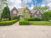 Charming two-story brick home with a manicured lawn and inviting walkway at 5784 N 600 E, Greenfield, IN 46140