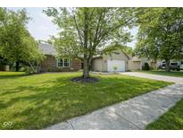 Charming single-story home with well-manicured lawn, brick accents, and attached two-car garage at 8391 Inland Dr, Avon, IN 46123