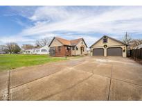 House exterior showcasing a two-car garage and driveway at 217 Federal Dr, Anderson, IN 46013