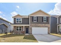 Two-story home featuring stone accents, a two-car garage, and well-maintained landscaping at 8131 Trailstay Dr, Camby, IN 46113