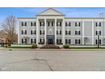 Attractive exterior with classical columns, symmetrical design, black shutters, and well-maintained landscaping at 12820 University Cres # 2D, Carmel, IN 46032