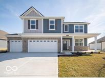 Charming two-story home with a three-car garage, covered porch, and attractive blue and gray siding at 287 Lar Lan Dr, Danville, IN 46122