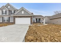 Charming two-story home with gray siding, brick accents, and an attached two-car garage at 235 Hunters Ridge Dr, Danville, IN 46122
