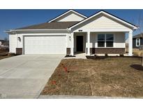Charming single-story home with a white exterior, stone accents, and a well-manicured lawn at 1426 Bluebonnet Pl, Shelbyville, IN 46176