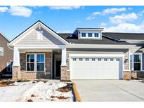 New construction home with gray siding, stone accents, and a two-car garage at 16972 Adler Ln, Noblesville, IN 46060