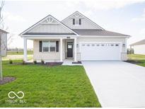 Charming single-story home with a well-maintained lawn, attached two car garage, and a covered front porch at 132 Velvet Hat Rd, Danville, IN 46122
