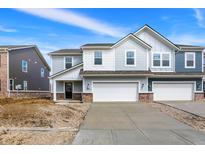 Charming two-story home with a two-car garage and well-lit concrete driveway at 2980 Grand Ridge Dr, Greenwood, IN 46143