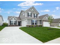 Charming two-story home featuring a manicured lawn, gray siding, black shutters, and a spacious two-car garage at 243 Hunters Ridge Dr, Danville, IN 46122