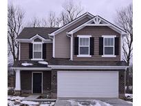Two-story home showcasing a brick facade, white trim, and a two-car garage at 3150 Lennon Ln, Indianapolis, IN 46235