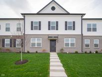 Charming townhome with a well-manicured lawn and a welcoming entrance, creating a warm curb appeal at 6227 Rhinecliff Dr, Whitestown, IN 46075