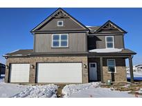 Two-story home with brick and gray siding, white garage doors, and snowy front yard at 6350 Granby Dr, Whitestown, IN 46075