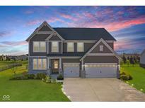 Two-story house with gray siding, three-car garage, and landscaped yard at sunset at 4225 Edelweiss Dr, Plainfield, IN 46168