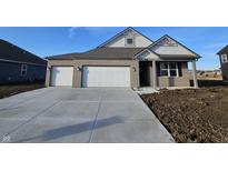 Charming brick home featuring a three-car garage and a welcoming front porch at 6322 Granby Dr, Whitestown, IN 46075