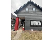 Two-story home with horizontal siding, red brick porch support, and front lawn at 1914 Union St, Indianapolis, IN 46225