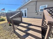 Nice wood deck with a lattice railing and steps leading to the grassy backyard at 741 N Somerset Ave, Indianapolis, IN 46222