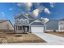 Beautiful two-story home with blue siding, white trim, stone accents, and an attached two-car garage at 19955 Boulder Brook Ln, Westfield, IN 46074