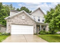 Charming two-story home with a brick facade, attached two-car garage, and well-maintained lawn at 5171 Alpine Violet Way, Indianapolis, IN 46254