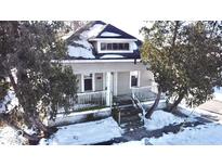 Gray house with front porch, steps, and landscaping; winter scene at 601 E Jackson St, Shelbyville, IN 46176