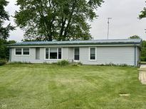 Charming single-story home with a well-manicured lawn, a metal roof, and attractive curb appeal at 8418 S State Road 39, Clayton, IN 46118
