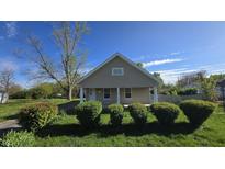 Charming home featuring tidy landscaping and a welcoming covered porch at 4745 W Legrande Ave, Indianapolis, IN 46241
