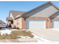 Brick ranch home with attached garage and landscaped yard at 4208 Payne Dr, Plainfield, IN 46168