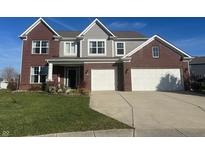 Two-story brick home with gray accents, two-car garage, and landscaped lawn at 2215 Dorothea Ct, Greenwood, IN 46143