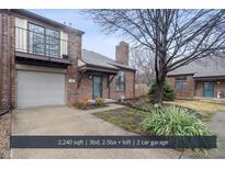 Charming brick home featuring a two-car garage and a small balcony off the upper level at 370 E Saint Clair St, Indianapolis, IN 46202