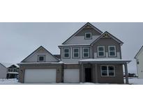 Two-story house with gray siding, two-car garage, and snowy landscape at 230 Hobbs Dr, Whiteland, IN 46184