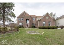 Classic brick two-story home featuring a manicured lawn and elegant architectural details at 11704 Gray Eagle Dr, Fishers, IN 46037