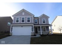 Two-story home with gray siding, white garage door, and stone accents at 3916 Highcrest Rd, Indianapolis, IN 46239