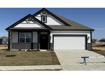 Beautiful new construction home with white siding, black trim, and a two-car garage at 107 Marble Wood Dr, Danville, IN 46122