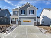 Two-story house with gray siding, and a two-car garage at 702 Penrose Pl, Danville, IN 46122