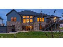 House exterior featuring a stone facade, large windows, and a deck at 1372 N Stoney Brook, Greenfield, IN 46140