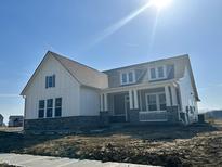 Charming two-story home featuring white siding, stone accents, and a welcoming front porch at 19566 Wood Farm Pl, Westfield, IN 46074