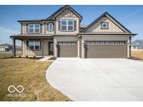 Charming two-story home featuring a neutral color scheme, two-car garage, and well-manicured lawn at 248 Highland Ave, Danville, IN 46122