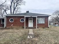 Brick ranch house with a covered entryway and a walkway at 4502 Evanston Ave, Indianapolis, IN 46205