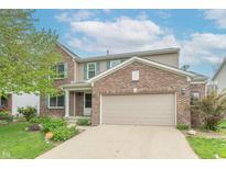 Charming two-story home with a brick facade, attached two-car garage, and well-maintained landscaping at 14446 Chapelwood Ln, Fishers, IN 46037